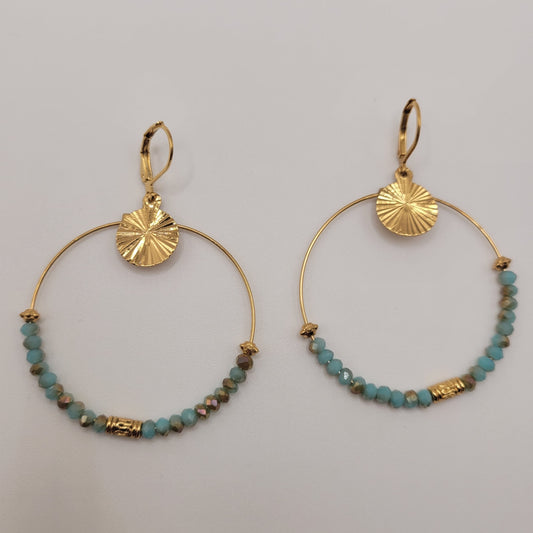 Nathalie, Boucles d'oreilles créoles dorées à l'or fin et perles facettées bleues.